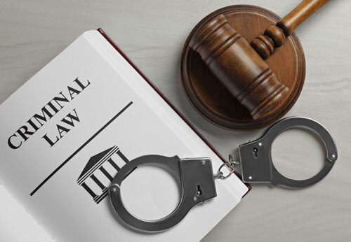 Police officer arresting a suspect, showcasing the complexities of criminal defense cases.