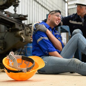 Construction worker being helped after an injury at a worksite, illustrating a Personal Injury case