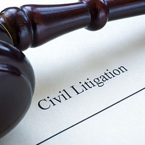 Gavel resting on Civil Litigation document, symbolizing court proceedings and law.